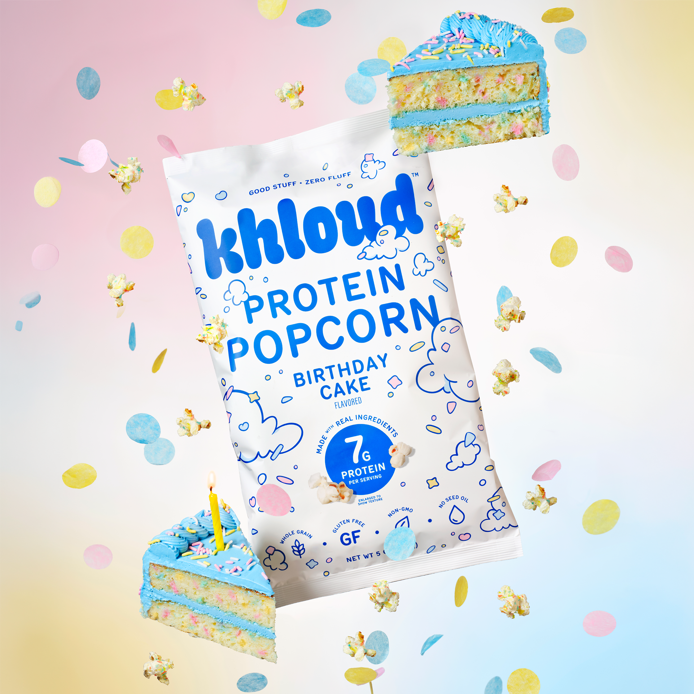 Khloud Birthday Cake Protein Popcorn bag surrounded by popcorn pieces and colorful birthday cake slices on pastel background.