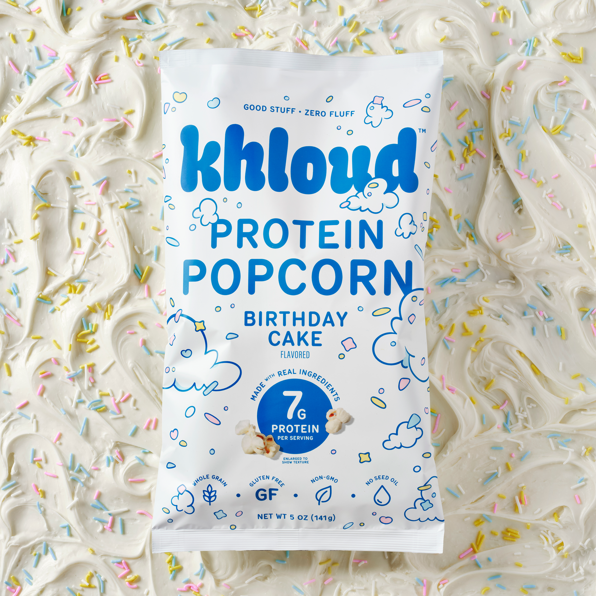 Khloud brand Birthday Cake protein popcorn bag on colorful sprinkle background.
